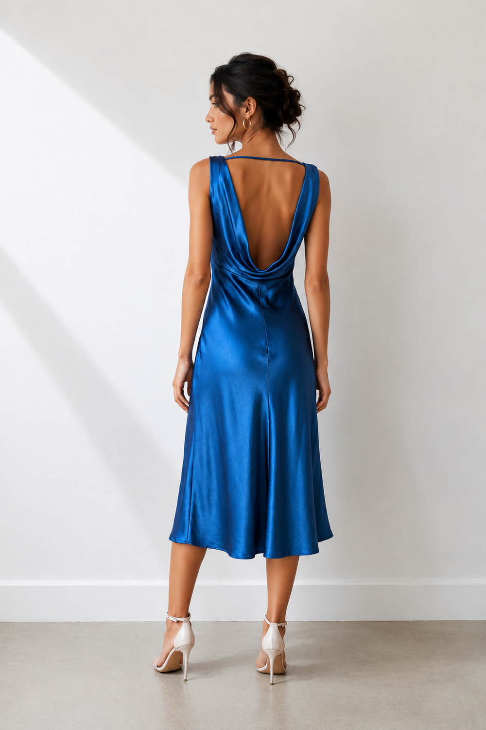 Woman wearing a blue dress against a white background